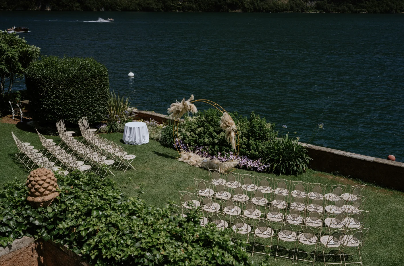 A lakeside ceremony setting prepared for guests